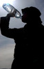 Soldier takes a long drink of bottled water Poster Print by Stocktrek Images - Item # VARPSTSTK101115M