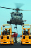 US Navy Sailors attach a sling to the belly of an HH-60H Seahawk helicopter Poster Print by Stocktrek Images - Item # VARPSTSTK102340M