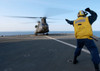 Boatswain's Mate signals to an Army CH-47 Chinook helicopter Poster Print by Stocktrek Images - Item # VARPSTSTK106565M