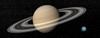 Large planet Saturn and its rings next to small planet Earth Poster Print by Elena Duvernay/Stocktrek Images - Item # VARPSTEDV200041S
