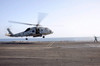 A helicopter landing signalman directs an SH-60F Sea Hawk Poster Print by Stocktrek Images - Item # VARPSTSTK106959M