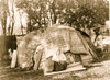 Klamath woman, full-length portrait, facing front, seated in front of house thatched with rush mats. Poster Print - Item # VARBLL058746986L