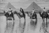 Camels with Native Riders on board stand in reflective floodwaters with a backdrop of the Pyramids of Giza In Egypt Poster Print by unknown - Item # VARBLL058745863L