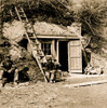 Two African American soldiers seated in front of small building in bottom of cliff, near Dutch Gap Canal. Poster Print - Item # VARBLL058745651L