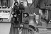 Suffragettes in Fur Adorned Coats and Mink Muffs stand in front of a Liberty Bell Replica which will accompany them in parade Poster Print by unknown - Item # VARBLL058745772L