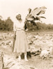 Woman, full-length portrait, standing in field, facing front, holding tobacco leaf, in Washington, D.C. area Poster Print - Item # VARBLL0587634782