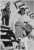 Indian descending wooden stairs with drum another in background looking on "Dance San Ildefonso Pueblo New Mexico 1942." 1942 Poster Print by Ansel Adams - Item # VARBLL0587401087