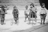 Children with Tricycles Playing in Manhattan Street Poster Print by unknown - Item # VARBLL058745777L