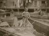 Truant hanging around boats in the harbor during school hours. Poster Print - Item # VARBLL058754421L