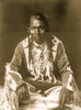 Wades in Water, Piegan Indian, full-length portrait, seated on floor, facing front, with braids, beaded buckskin shirt and leggings, beads with ermine tail trim Poster Print - Item # VARBLL058747557L