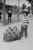 Young Cowboy, "Fog Horn Clancey" stand beside saddle bag and lasso Poster Print by unknown - Item # VARBLL058724349x