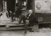 Dependent Widower sits on steps; the children work to support him Poster Print - Item # VARBLL058754913L