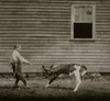 Boy holds a small calf by a rope as his Mother loo0ks on Poster Print - Item # VARBLL058755233L