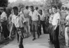 African American boy walking through a crowd of white boys during a period of violence related to school integration. Poster Print - Item # VARBLL0587633344