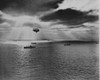 Sunset over the Atlantic finds another United Nations convoy moving peacefully towards it destination. A U.S. Navy blimp, hovering watchfully overhead, is on the lookout for any sign of enemy submarines Poster Print - Item # VARBLL058748170L