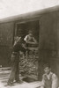 Young boy working for Hickok Lumber Co. Unloading wood from a boxcar Poster Print - Item # VARBLL058754398L