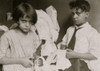 Young boy and young girl cutting fabric in work taken in at home in their tenement Poster Print - Item # VARBLL058754532L