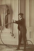 Frances Benjamin Johnston, full-length self-portrait dressed as a man with false moustache, posed with a penny farthing bicycle, facing left Poster Print - Item # VARBLL058746217L