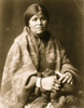 Navajo woman, half-length portrait, seated, facing front, holding yarn, facing slightly right. Poster Print - Item # VARBLL058747723L