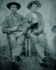 Tintype - Two Cowboys With Drawn Weapons A Sixth Plate Tintype Of Two Cowboys Seated, And Posed Identically With Right Arms Across Their Chests Holding Their Revolvers, And Left Hands Resting In Their Laps. Poster Print - Item # VARBLL0587402024