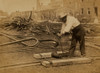 Railroad construction worker straightening track; pile of twisted rails in background. 1862-63 Poster Print - Item # VARBLL058745597L