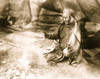 Navajo Indian warming hands over fire in tepee. Poster Print - Item # VARBLL058751185L