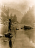 Hupa man with spear, standing on rock midstream, in background, fog partially obscures trees on mountainsides. Poster Print - Item # VARBLL058746840L
