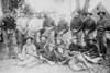 Group of Men Both Seated on Ground and Standing hold Rifles & Wear both Uniforms and Civilian Clothing Poster Print - Item # VARBLL058746112L