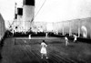 On the deck of a luxury liner a group of cruise ship passengers play tennis near the ship stacks. Poster Print by unknown - Item # VARBLL0587008369