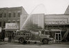 firefighters spraying water on shops, including Beyda's, Miles Shoes, and Graysons, that were burned during the riots that followed the assassination of Martin Luther King, Jr. Poster Print - Item # VARBLL058750234L