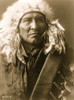 Bread, an Apsaroke Indian, head-and-shoulders portrait, facing front, wearing a headdress. Poster Print - Item # VARBLL058746949L
