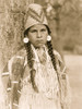 Umatilla woman, half-length portrait, facing front, standing in front of tree, wearing beaded buckskin dress, shell bead necklaces, shell disk earrings, and woven grass hat. Poster Print - Item # VARBLL058747571L