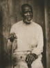 African American man, three-quarter length portrait, seated, facing front, right hand holding cane, left hand on lap Poster Print - Item # VARBLL0587633689