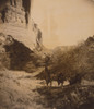 Group of Navajos, most on horseback, pause at the bottom of a rocky canyon. Poster Print - Item # VARBLL058747021L