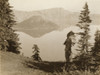 Klamath Indian chief in ceremonial headdress standing on hill overlooking lake, California or Oregon. Poster Print - Item # VARBLL058746966L