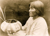 Native American woman, half-length portrait, seated facing left, holding basket. Poster Print - Item # VARBLL058746981L