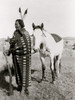 Sioux Indian, full-length portrait, facing left, holding rifle, in front of horse. Poster Print - Item # VARBLL058751195L