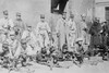 Machine Gunners in Mexico City; Soldiers Crouch on Ground in City Setting with their Officers in Kepis overlooking their men Poster Print - Item # VARBLL058746120L