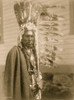 Piegan man, half-length portrait, dressed in war bonnet and holding a feathered coup-stick, facing front. Poster Print - Item # VARBLL058747676L