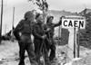 Canadian Soldiers At A Sign For The Port City Of Caen History - Item # VAREVCHISL037EC122