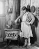 The Teenage Daughter Of A An Impoverished Arkansas Farmer Cooking On An Old Stove While Her Mother Was In A Tuberculosis Sanitarium During The Great Depression. Red Cross Photo From Ca. 1930. History - Item # VAREVCHISL014EC129