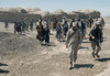 Villagers From Nojoy Outside Kandahar International Airport Follow The Members Of The U.S. Army'S Tactical Psychological Operations Team As They Leave After Meeting With The Village Elders. April 16 2002. History - Item # VAREVCHISL024EC130