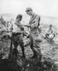 U.S. Soldier Of Lights A Cigarette For A Former Enemy Guard. They Are At A Surrender Conference Between American And Japanese Officers On A Sierra Madre Mountain Top In Northern Luzon History - Item # VAREVCHISL037EC820