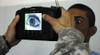 An Iraqi Police Recruit Holds His Eye Open For A Retinal Scan Administered By A Us Soldier In Mahmudiyah Iraq May 30 2007. History - Item # VAREVCHISL028EC016