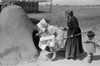 Two Spanish-American Women Placing Loaves Of Bread In Outdoor Earthen Oven For Baking History - Item # VAREVCHISL033EC196