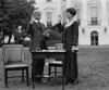 First Lady Grace Coolidge Taking An Oath Before Filling Out Her Ballot For The 1924 Election. President Calvin Coolidge Stands In The Background. History - Item # VAREVCHISL040EC646