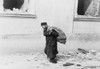 A Solitary Jewish Man Carrying A Sack Walking Past Bomb Damaged Buildings In Poland In The Early Days Of World War Ii. 1939-40. History - Item # VAREVCHISL012EC254