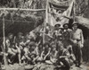 New Guinean Natives And Allied Troops Pause At A Ymca In The Jungle. The Natives Aided The Allied Forces Against The Japanese By Transporting Supplies And Wounded Soldiers Through The Rain Forest. March 1943. History - Item # VAREVCHISL036EC541