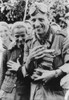 German Soldier Holding An Armful Of Sliced Bread With Several Young Ukrainian Women. German Propaganda Photo Of Welcoming Ukrainians During Operation Barbarossa Invasion. Oct. 1941. World War 2. History - Item # VAREVCHISL036EC905