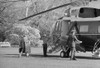 President Jimmy Carter Walking Toward Marine 1 The Presidential Helicopter Carrying His Own Luggage. Ca. 1977-80. History - Item # VAREVCHISL029EC059